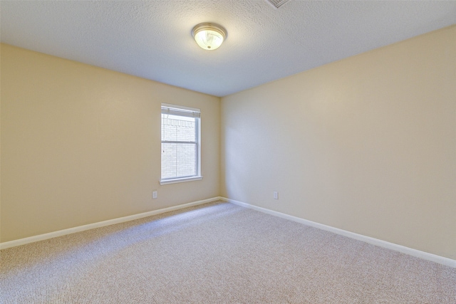 unfurnished room featuring carpet floors and a textured ceiling