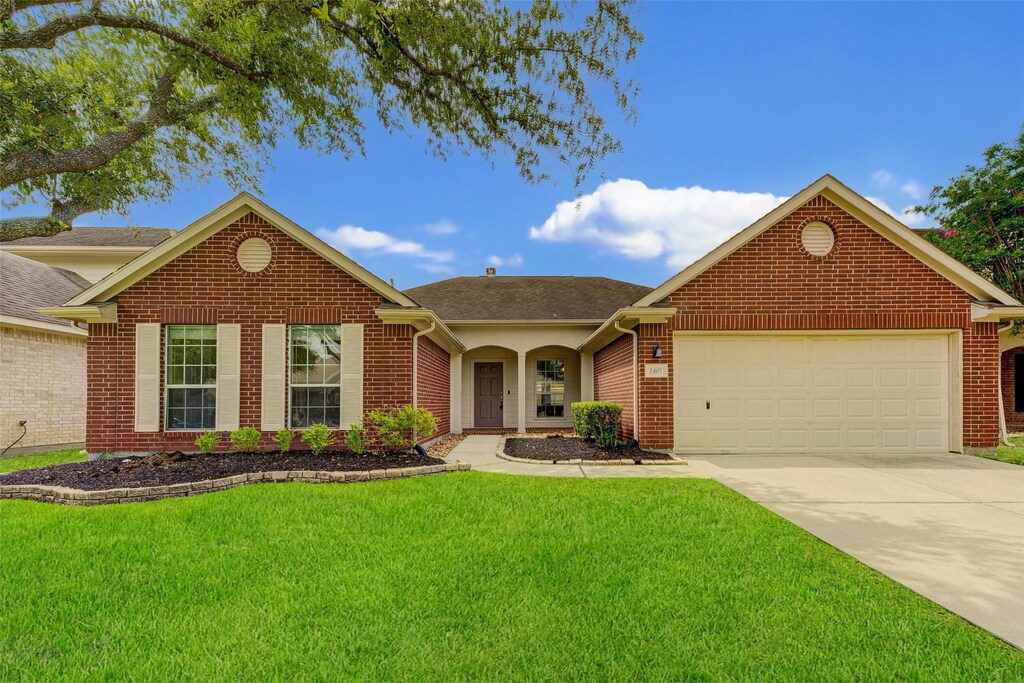 2407 Daneswood, Spring, TX 77388 - view of front facade featuring a front yard and a garage