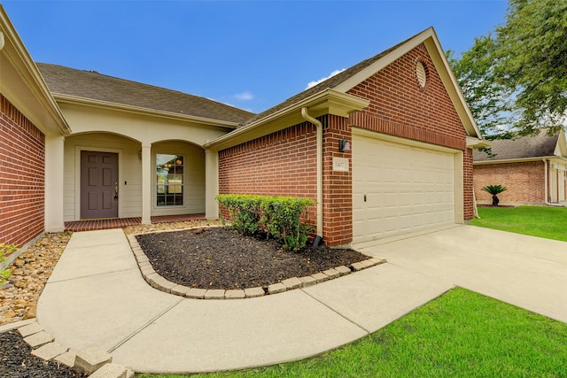 doorway to property with a garage