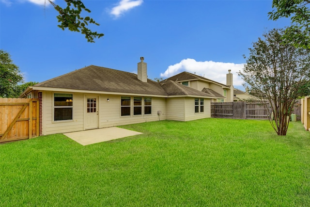 rear view of house with a patio area and a yard