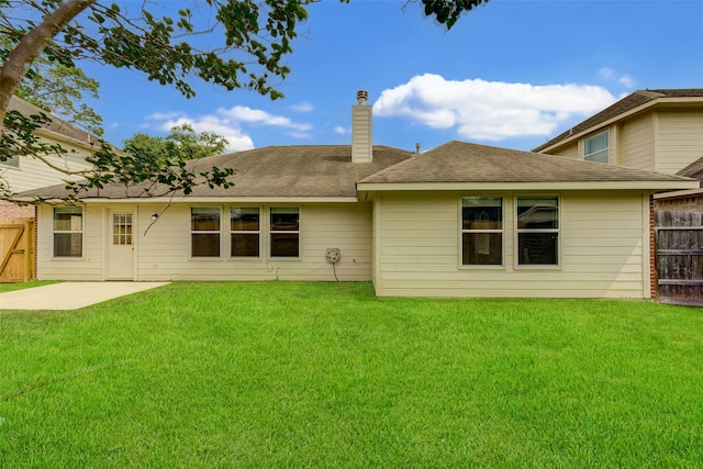 rear view of house with a yard