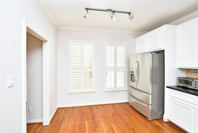 kitchen with white cabinets, light hardwood / wood-style floors, stainless steel refrigerator with ice dispenser, and ornamental molding