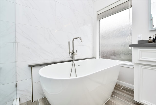 bathroom featuring a bathtub, vanity, and hardwood / wood-style flooring