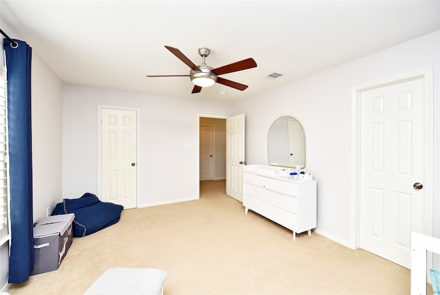 sitting room with light carpet and ceiling fan