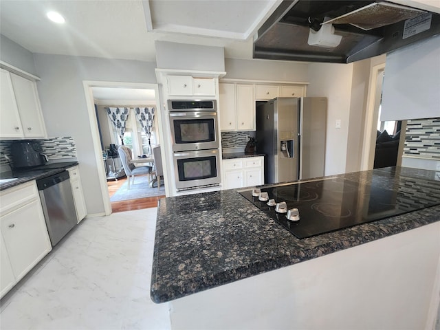 kitchen featuring under cabinet range hood, marble finish floor, appliances with stainless steel finishes, and white cabinetry