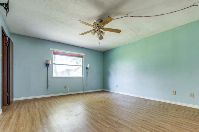 empty room with ceiling fan, a textured ceiling, and light hardwood / wood-style flooring