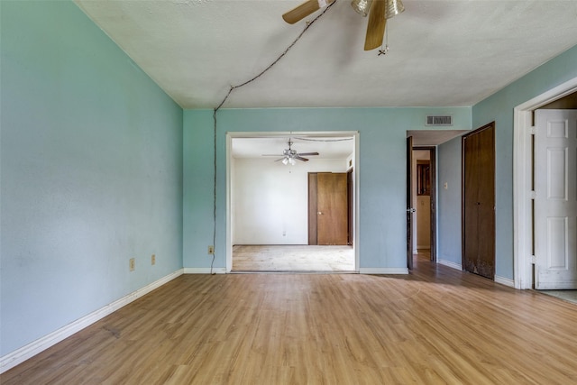 spare room featuring light hardwood / wood-style flooring and ceiling fan