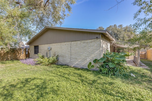 view of side of property with a yard