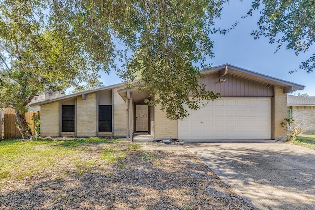 2714 Killdeer Ln, Humble, TX 77396 - mid-century inspired home with brick siding, a garage, and concrete driveway