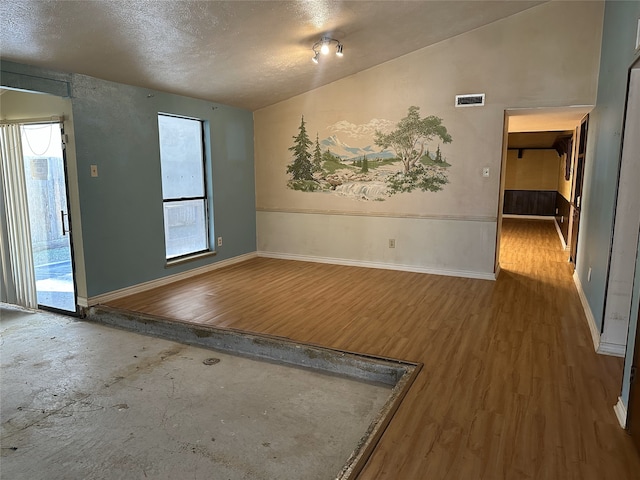 empty room featuring hardwood / wood-style floors and a textured ceiling