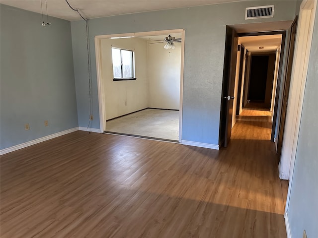 unfurnished room featuring hardwood / wood-style flooring and ceiling fan