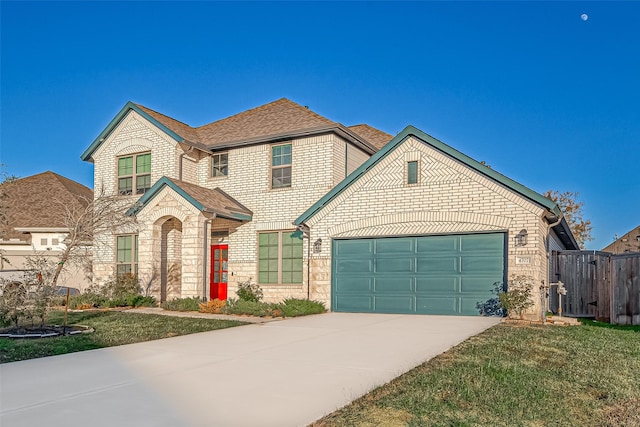 view of front of property featuring a front yard and a garage