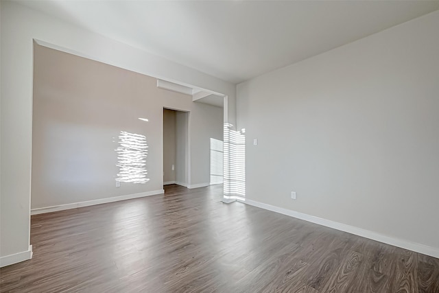 unfurnished room featuring dark wood-type flooring