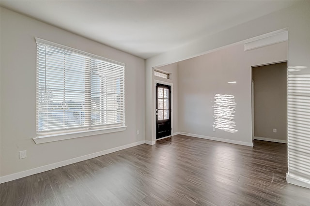 empty room featuring dark hardwood / wood-style flooring