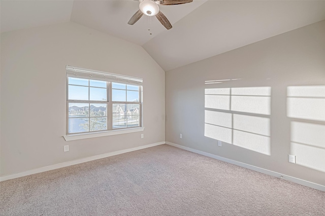 empty room with ceiling fan, light carpet, and vaulted ceiling