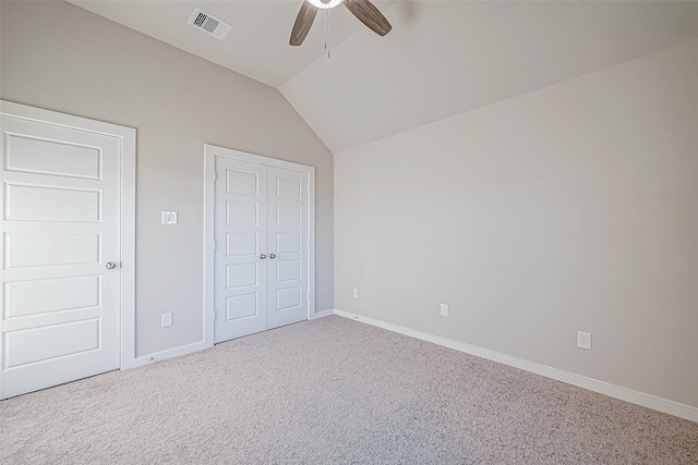 unfurnished bedroom featuring carpet, ceiling fan, and vaulted ceiling