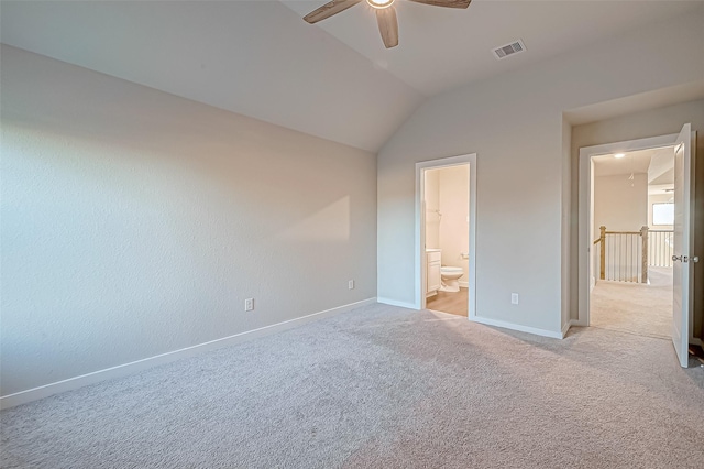 unfurnished bedroom with ensuite bath, ceiling fan, light colored carpet, and lofted ceiling