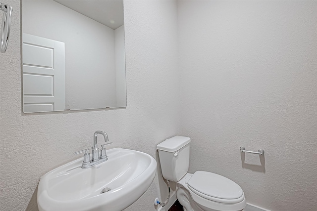 bathroom with toilet and sink