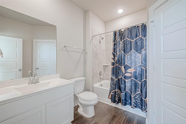 full bathroom featuring hardwood / wood-style flooring, vanity, toilet, and shower / bath combo with shower curtain