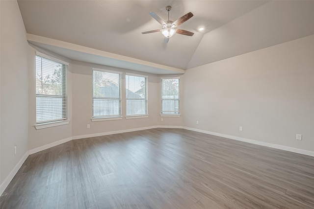 empty room featuring ceiling fan, vaulted ceiling, and hardwood / wood-style flooring