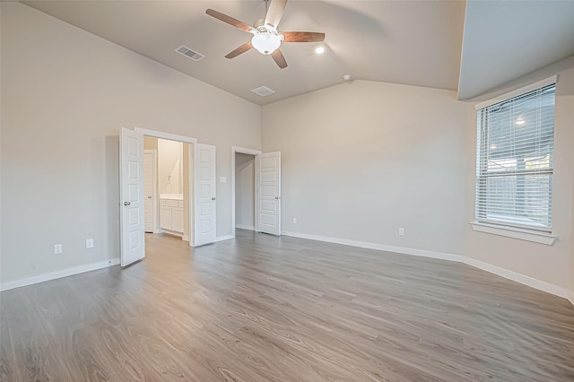 empty room with ceiling fan, wood-type flooring, and lofted ceiling