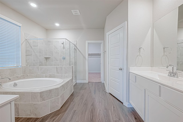 bathroom featuring vanity, wood-type flooring, and independent shower and bath