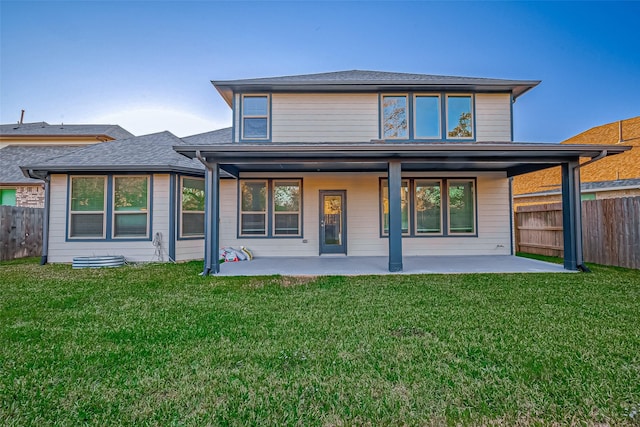 rear view of property featuring a yard and a patio