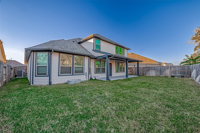 back of property featuring a yard, a patio, and central AC