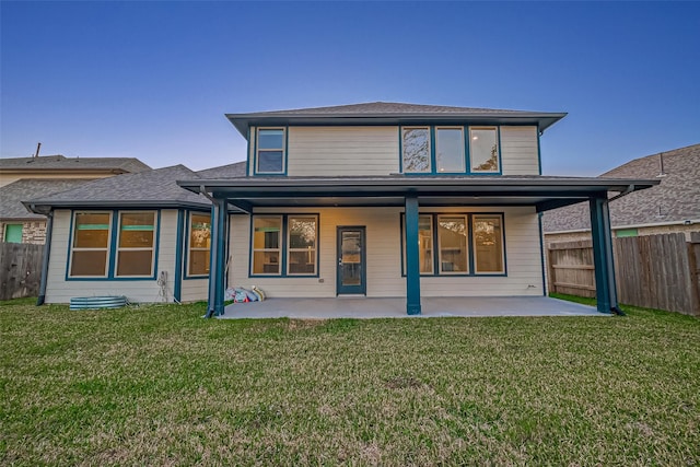 back of property featuring a patio and a lawn