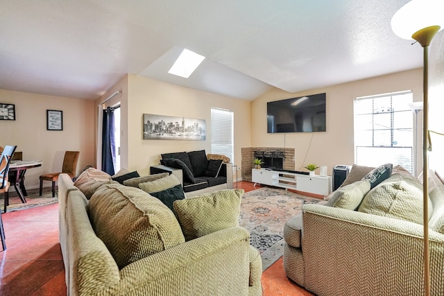 tiled living room with lofted ceiling and a brick fireplace