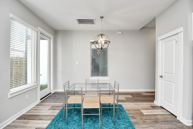 unfurnished dining area with light hardwood / wood-style flooring and a chandelier