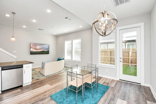 dining room with a notable chandelier and light hardwood / wood-style floors