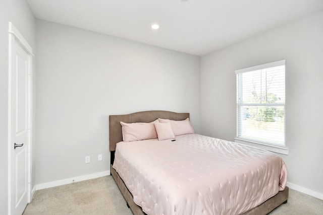 bedroom featuring light carpet