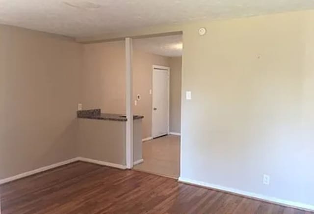 spare room featuring dark hardwood / wood-style flooring