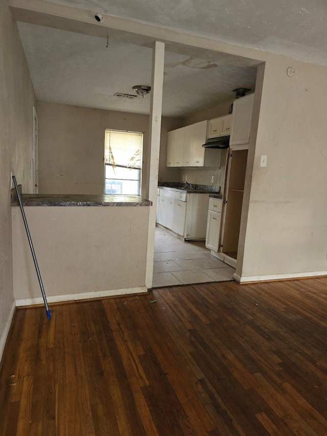 kitchen featuring white cabinets and light hardwood / wood-style floors