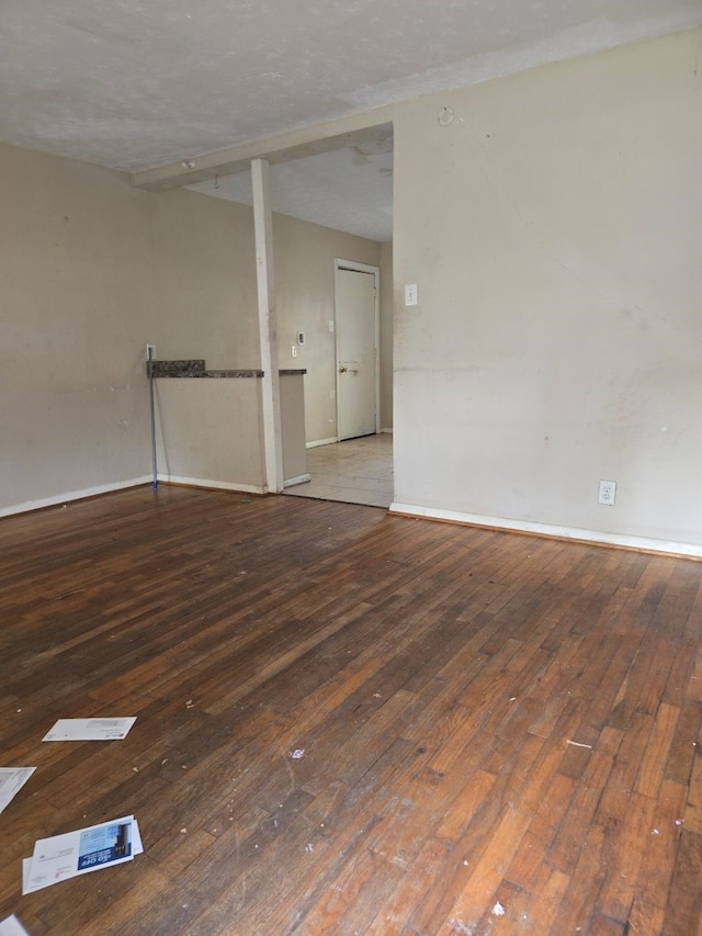 spare room with a textured ceiling and hardwood / wood-style flooring