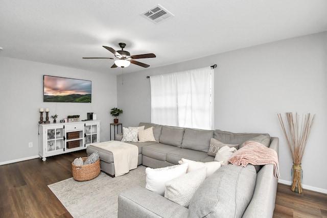 living room with ceiling fan and dark wood-type flooring