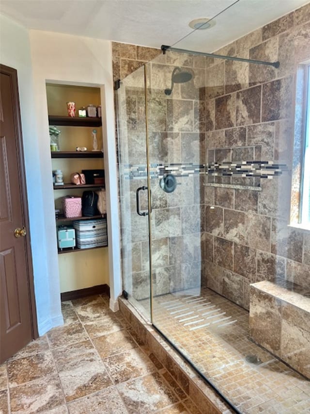 bathroom with a shower with door