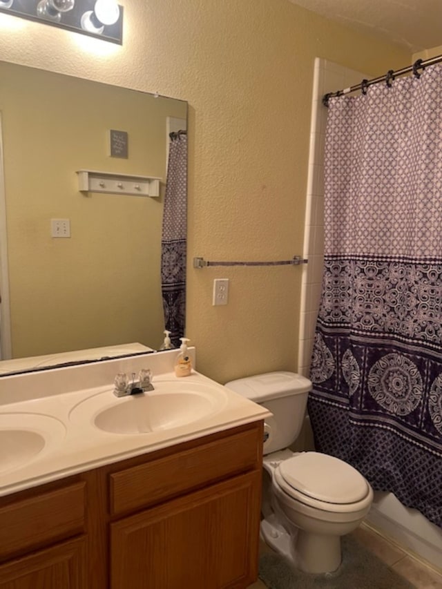 bathroom with a shower with shower curtain, vanity, toilet, and tile patterned flooring