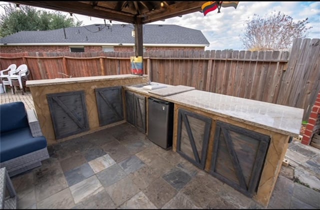 view of patio featuring an outdoor kitchen