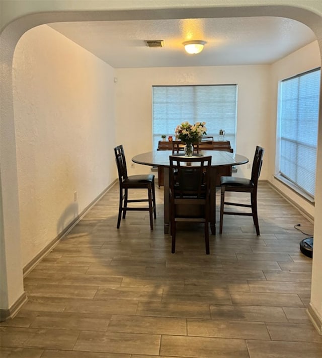 dining space featuring dark hardwood / wood-style floors