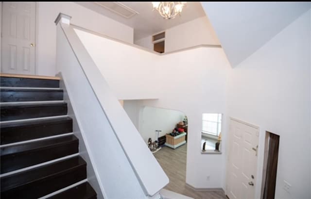 stairs featuring hardwood / wood-style floors