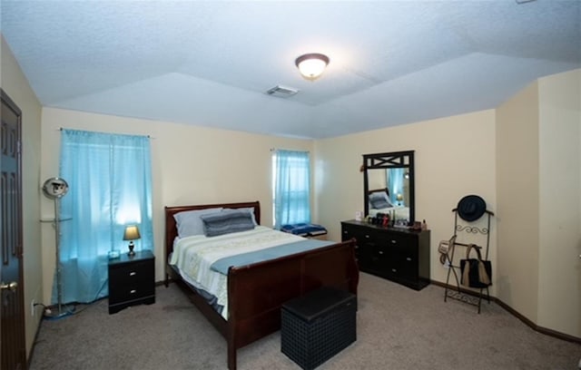 carpeted bedroom featuring lofted ceiling