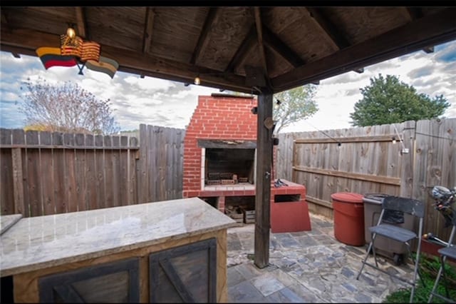 view of patio / terrace featuring a gazebo, an outdoor bar, and an outdoor fireplace