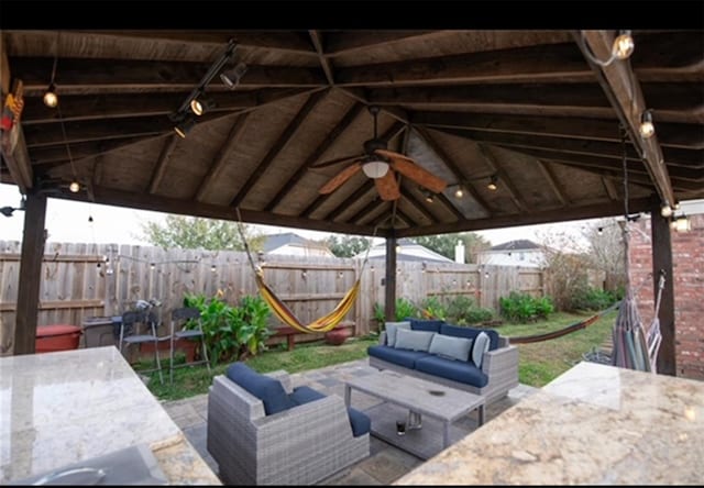 view of patio featuring a gazebo, ceiling fan, and an outdoor hangout area