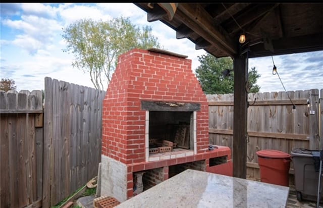 view of patio / terrace with an outdoor fireplace