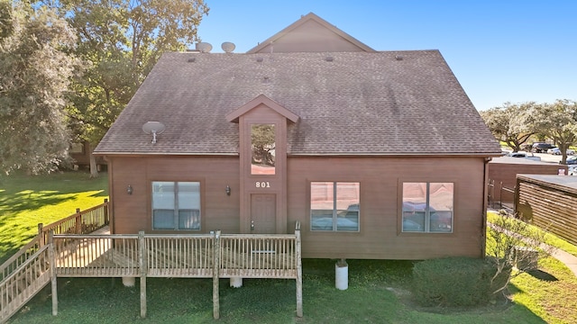 back of house with a lawn