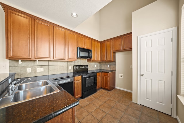 kitchen featuring backsplash, tile patterned floors, a textured ceiling, sink, and black appliances