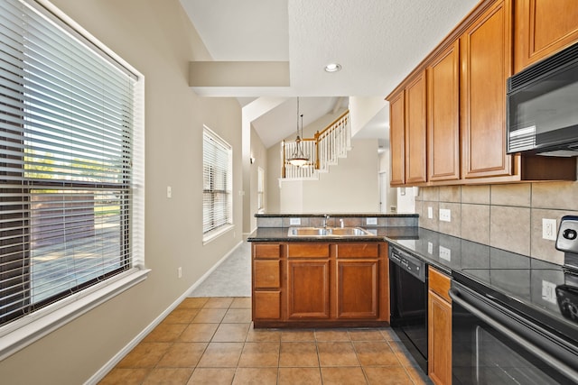 kitchen featuring black appliances, decorative light fixtures, light tile patterned floors, and sink