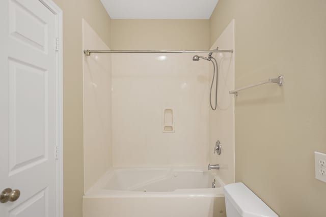 bathroom featuring shower / bathtub combination and toilet